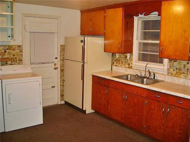 482 Fieldcrest Dr, Pittsburg, KS 66762 - kitchen featuring washer / clothes dryer, light countertops, freestanding refrigerator, and tasteful backsplash