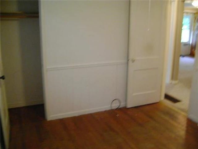 482 Fieldcrest Dr, Pittsburg, KS 66762 - unfurnished bedroom featuring wood finished floors and a closet