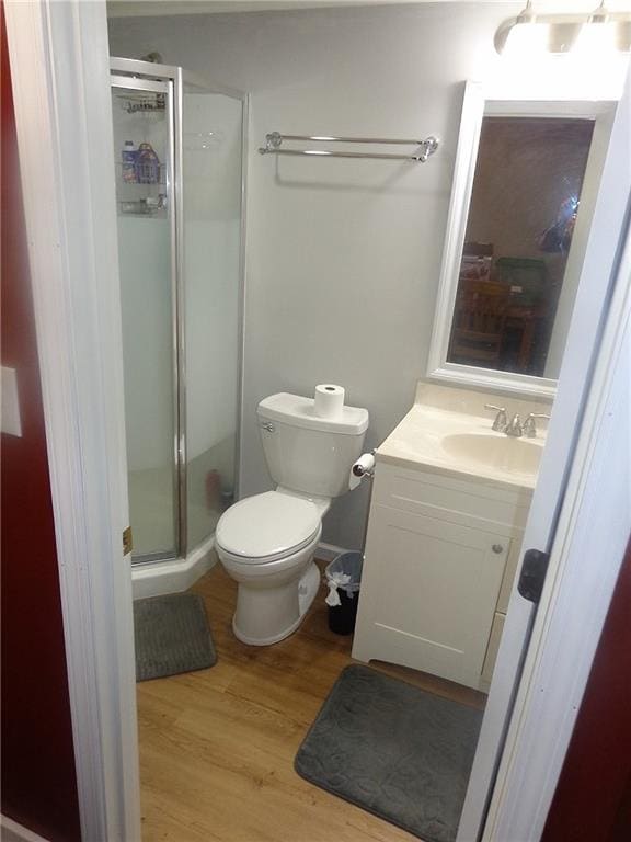482 Fieldcrest Dr, Pittsburg, KS 66762 - full bath with wood finished floors, vanity, and a shower stall