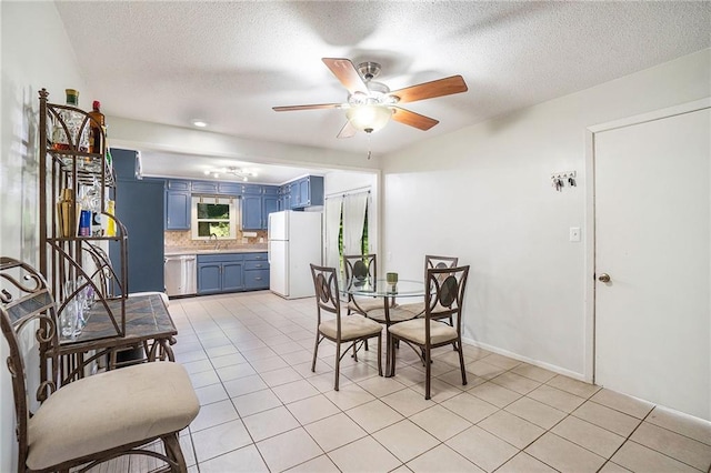 2110 N 70th Ter, Kansas City, KS 66109 - dining room featuring a ceiling fan, light tile patterned flooring, and a textured ceiling