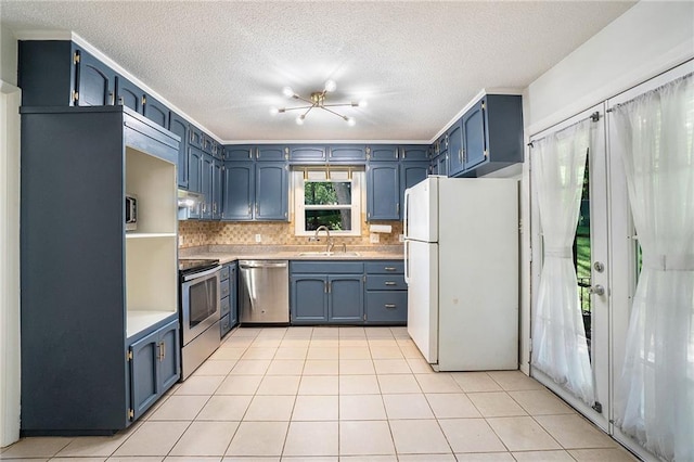 2110 N 70th Ter, Kansas City, KS 66109 - kitchen with stainless steel appliances, backsplash, blue cabinets, a textured ceiling, and light tile patterned floors