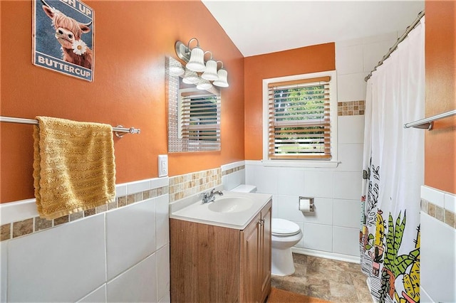 2110 N 70th Ter, Kansas City, KS 66109 - full bathroom with vanity, tile walls, curtained shower, and stone finish flooring