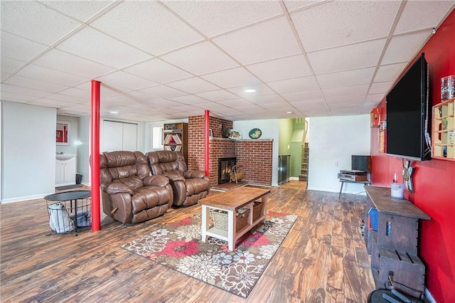 2110 N 70th Ter, Kansas City, KS 66109 - living area featuring a fireplace, wood finished floors, and a paneled ceiling
