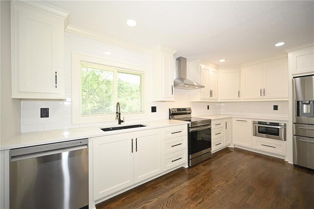 6309 E 102nd Ter, Kansas City, MO 64134 - kitchen with stainless steel appliances, wall chimney range hood, light countertops, decorative backsplash, and recessed lighting