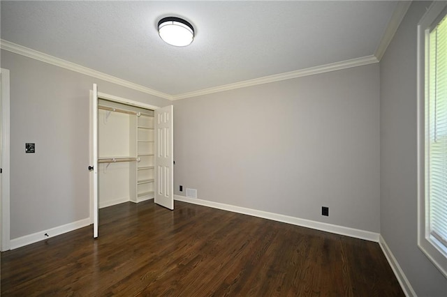 6309 E 102nd Ter, Kansas City, MO 64134 - unfurnished bedroom featuring dark wood-style flooring, crown molding, and a closet