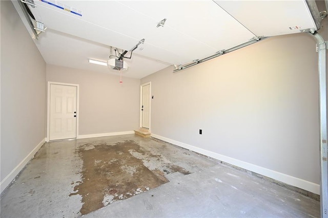6309 E 102nd Ter, Kansas City, MO 64134 - garage featuring baseboards and a garage door opener