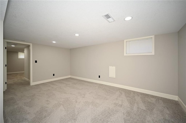 6309 E 102nd Ter, Kansas City, MO 64134 - finished basement with carpet, recessed lighting, and a textured ceiling