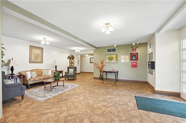 8001 Westridge Rd Unit 103, Raytown, MO 64138 - living area featuring a textured ceiling and track lighting