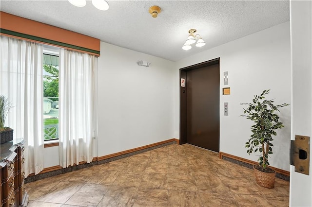 8001 Westridge Rd Unit 103, Raytown, MO 64138 - foyer featuring elevator and a textured ceiling