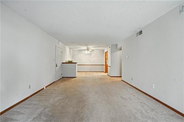 8001 Westridge Rd Unit 103, Raytown, MO 64138 - unfurnished living room featuring light colored carpet, a ceiling fan, and a textured ceiling