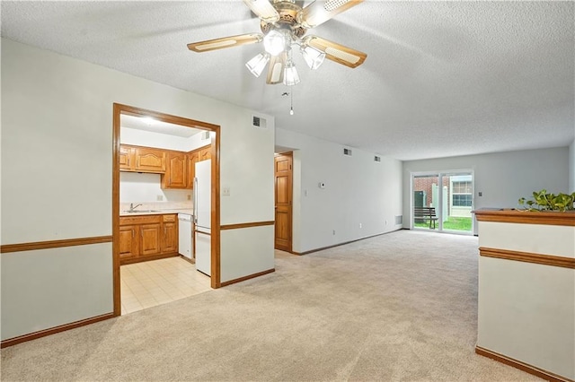 8001 Westridge Rd Unit 103, Raytown, MO 64138 - unfurnished living room with light carpet, a textured ceiling, and ceiling fan