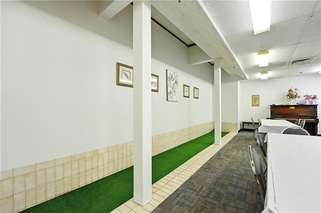 8001 Westridge Rd Unit 103, Raytown, MO 64138 - basement with carpet flooring, golf simulator, and tile patterned flooring