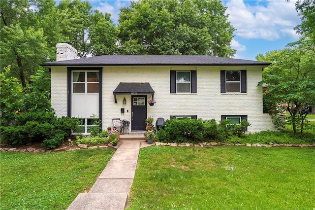 16722 E 35th Ter, Independence, MO 64055 - bi-level home with a chimney, a front lawn, and brick siding
