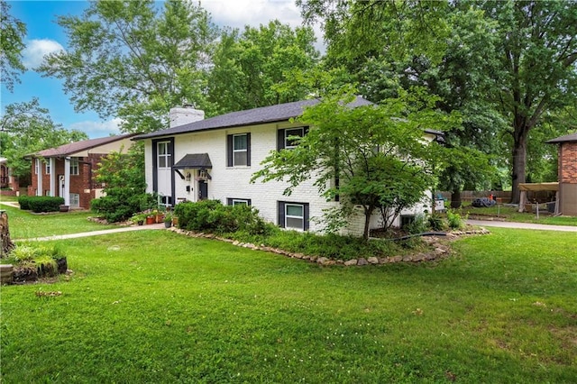 16722 E 35th Ter, Independence, MO 64055 - split foyer home with brick siding, a chimney, and a front yard