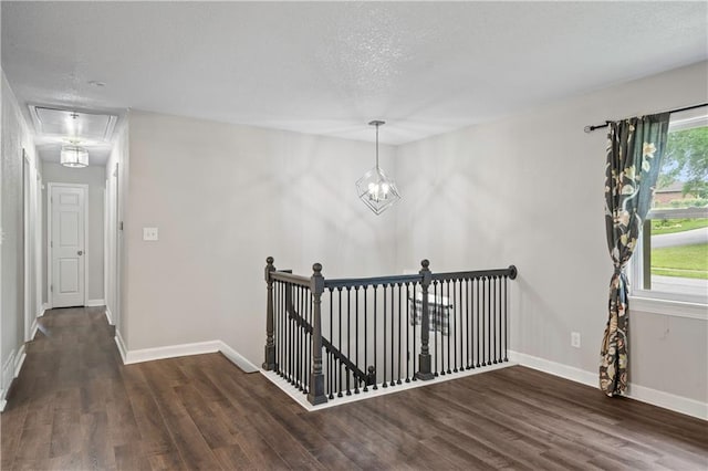 16722 E 35th Ter, Independence, MO 64055 - hallway featuring a textured ceiling, wood finished floors, an upstairs landing, a chandelier, and attic access
