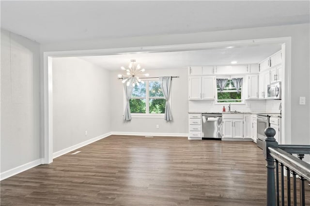 16722 E 35th Ter, Independence, MO 64055 - kitchen with stainless steel appliances, white cabinets, dark wood-type flooring, a chandelier, and light countertops
