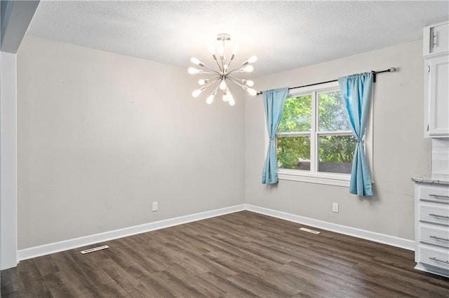 16722 E 35th Ter, Independence, MO 64055 - unfurnished dining area with a chandelier, dark wood finished floors, and a textured ceiling