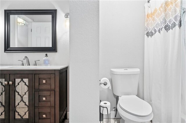 16722 E 35th Ter, Independence, MO 64055 - full bath with vanity, a textured wall, and a shower with shower curtain