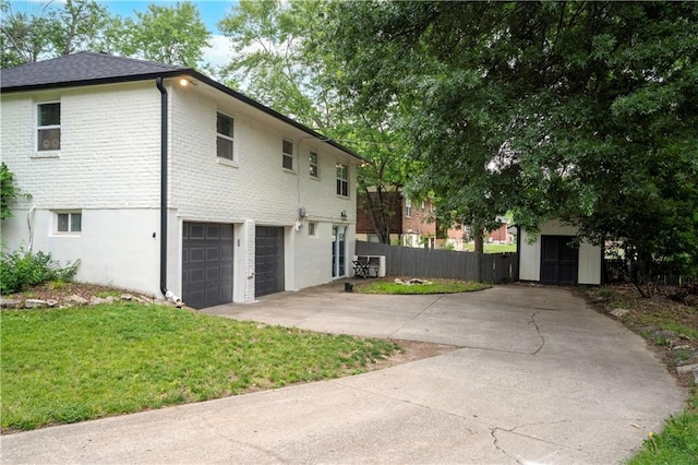 16722 E 35th Ter, Independence, MO 64055 - view of side of property with driveway, a garage, brick siding, and a storage shed