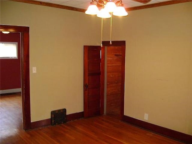 1918 S Elm St, Pittsburg, KS 66762 - unfurnished room featuring wood finished floors, ornamental molding, and a chandelier