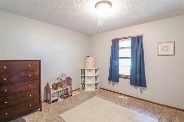 304 NE Independence Ave Unit B, Lees Summit, MO 64063 - carpeted bedroom with a textured ceiling and baseboards