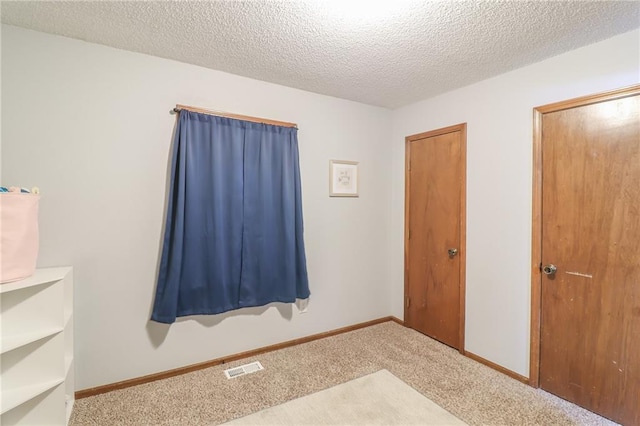 304 NE Independence Ave Unit B, Lees Summit, MO 64063 - unfurnished bedroom featuring carpet flooring and a textured ceiling