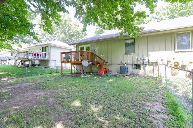 304 NE Independence Ave Unit B, Lees Summit, MO 64063 - rear view of property with board and batten siding, stairs, a deck, and a fenced backyard