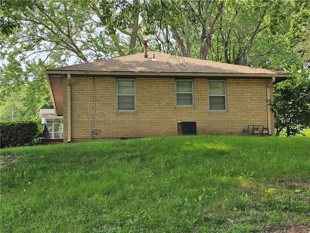 524 E Walnut St, Independence, MO 64050 - view of property exterior featuring brick siding, crawl space, roof with shingles, and a lawn