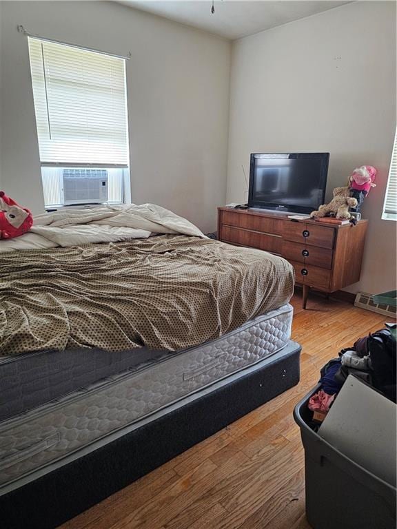 524 E Walnut St, Independence, MO 64050 - bedroom featuring wood finished floors and cooling unit