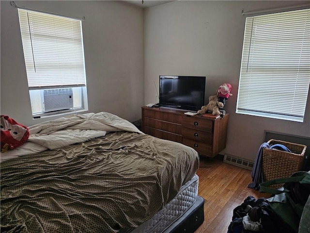 524 E Walnut St, Independence, MO 64050 - bedroom featuring wood finished floors, multiple windows, and cooling unit