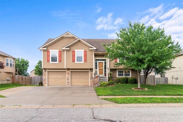 610 NW Green Dr, Grain Valley, MO 64029 - split foyer home featuring concrete driveway, an attached garage, and stone siding