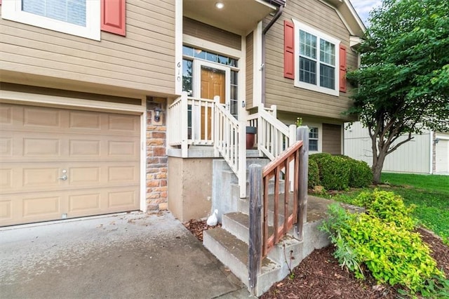 610 NW Green Dr, Grain Valley, MO 64029 - view of exterior entry featuring stone siding and an attached garage