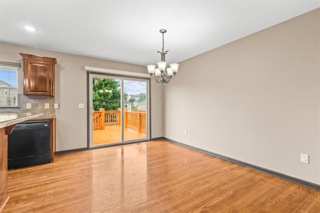 610 NW Green Dr, Grain Valley, MO 64029 - unfurnished dining area featuring a chandelier, light wood-style flooring, and recessed lighting