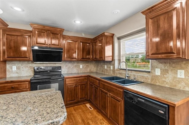 610 NW Green Dr, Grain Valley, MO 64029 - kitchen featuring black appliances, light wood-style flooring, backsplash, light countertops, and recessed lighting