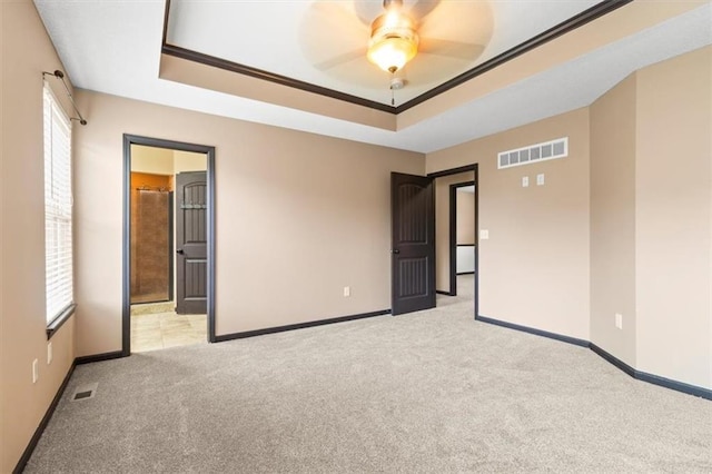 610 NW Green Dr, Grain Valley, MO 64029 - unfurnished room featuring light carpet, a tray ceiling, ornamental molding, and ceiling fan