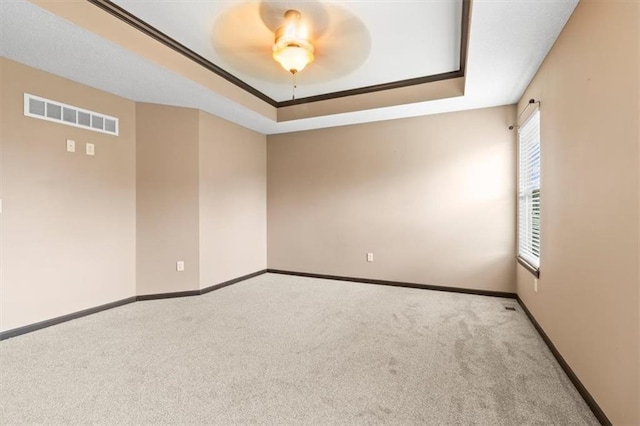 610 NW Green Dr, Grain Valley, MO 64029 - carpeted spare room with a raised ceiling and a ceiling fan