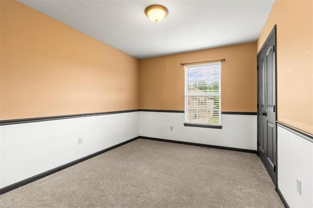 610 NW Green Dr, Grain Valley, MO 64029 - spare room with carpet and a textured ceiling