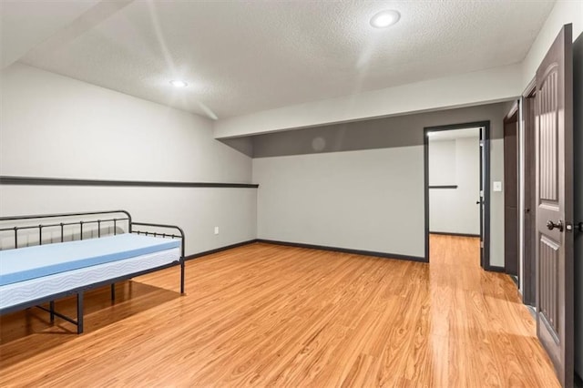 610 NW Green Dr, Grain Valley, MO 64029 - bedroom featuring a textured ceiling, light wood-style flooring, and recessed lighting