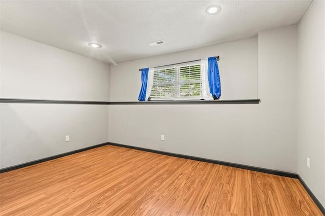 610 NW Green Dr, Grain Valley, MO 64029 - spare room featuring wood finished floors, recessed lighting, and a textured ceiling