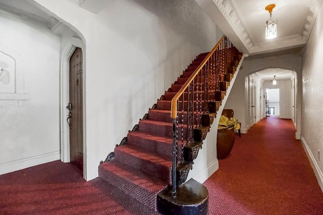 700 W 48th St Unit 301, Kansas City, MO 64112 - stairway featuring carpet, arched walkways, and ornamental molding