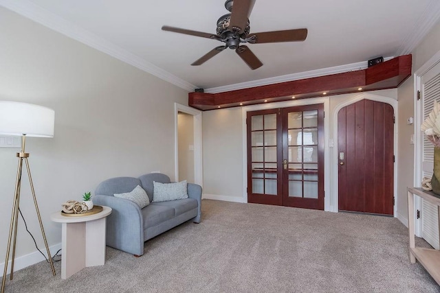 700 W 48th St Unit 301, Kansas City, MO 64112 - living area featuring french doors, ornamental molding, carpet, ceiling fan, and arched walkways