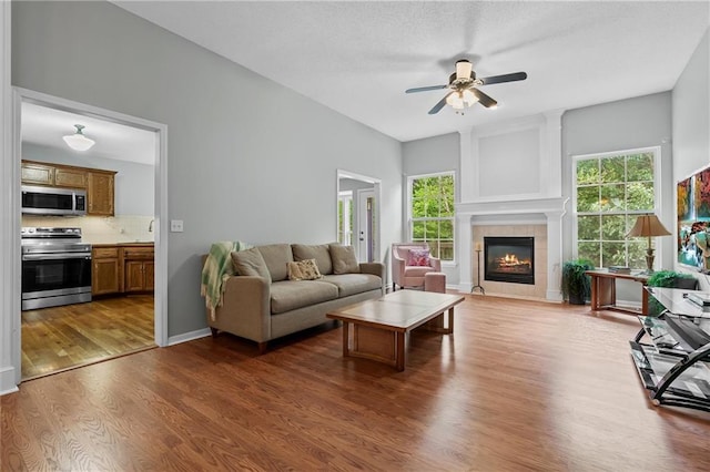 4116 NE 83rd St, Kansas City, MO 64119 - living room with a ceiling fan, wood finished floors, and a fireplace