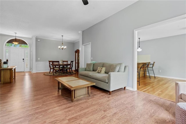 4116 NE 83rd St, Kansas City, MO 64119 - living area with light wood-style flooring, a chandelier, and a wainscoted wall