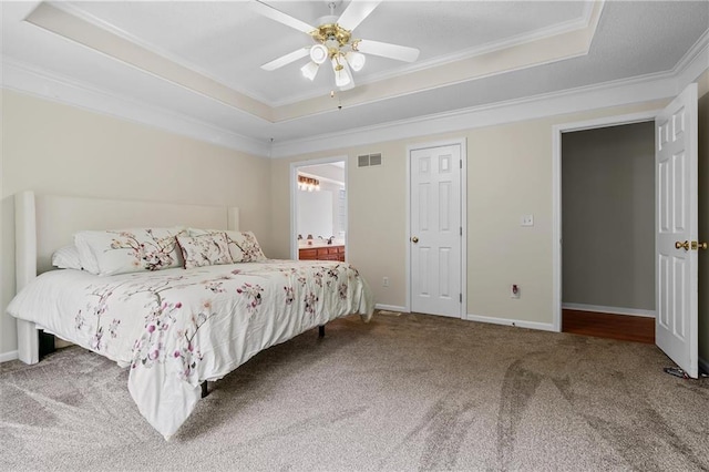 4116 NE 83rd St, Kansas City, MO 64119 - carpeted bedroom with a raised ceiling, ornamental molding, a ceiling fan, and ensuite bathroom