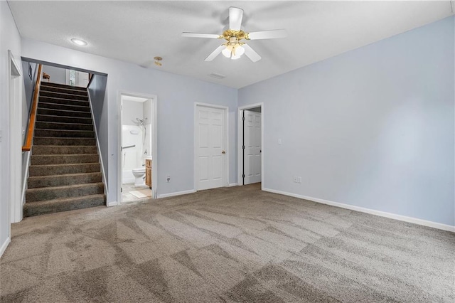 4116 NE 83rd St, Kansas City, MO 64119 - carpeted empty room with a ceiling fan and stairway