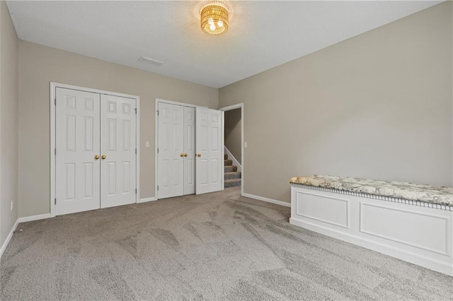 4116 NE 83rd St, Kansas City, MO 64119 - unfurnished bedroom with carpet floors and two closets