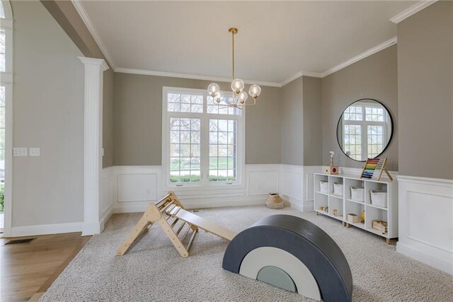 9500 N Lane Ave, Kansas City, MO 64157 - playroom featuring plenty of natural light, a chandelier, ornamental molding, wainscoting, and wood finished floors