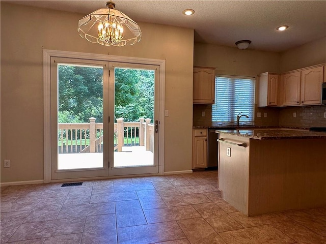 15598 S Blackfeather St, Olathe, KS 66062 - kitchen with a chandelier, dark stone countertops, pendant lighting, appliances with stainless steel finishes, and recessed lighting