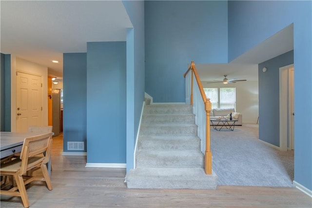 404 Wyndham Dr, Lansing, KS 66043 - stairway featuring ceiling fan, wood finished floors, and recessed lighting