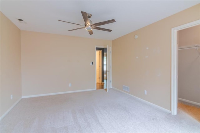 404 Wyndham Dr, Lansing, KS 66043 - unfurnished bedroom with a spacious closet, carpet, a closet, and a ceiling fan